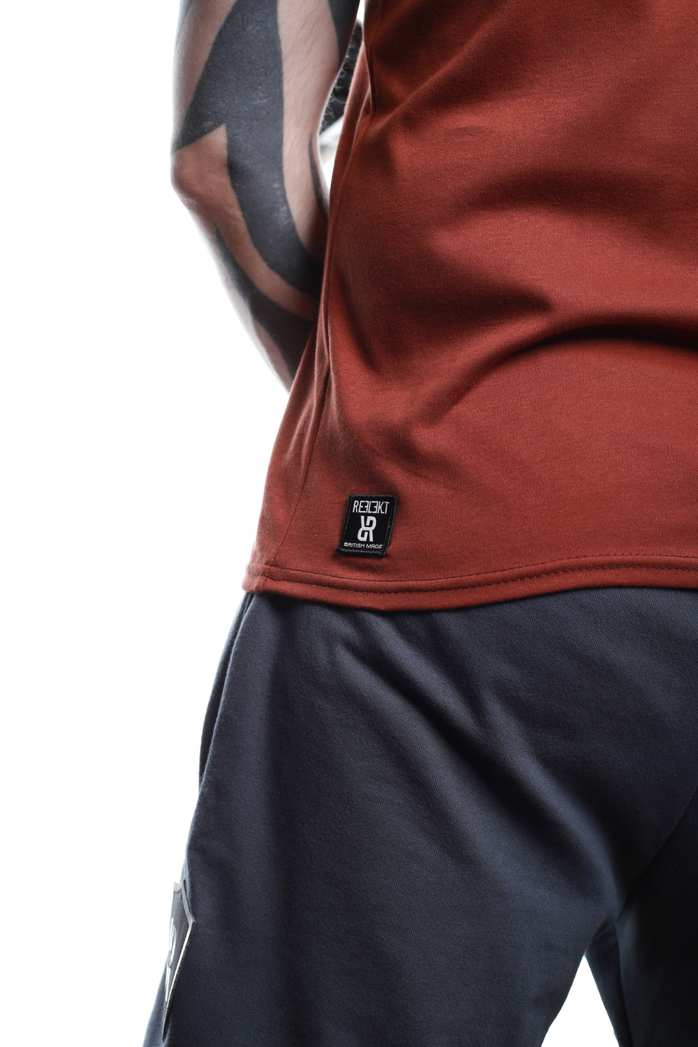 Insignia patch on Rust‑coloured REFLEKT blank vest.