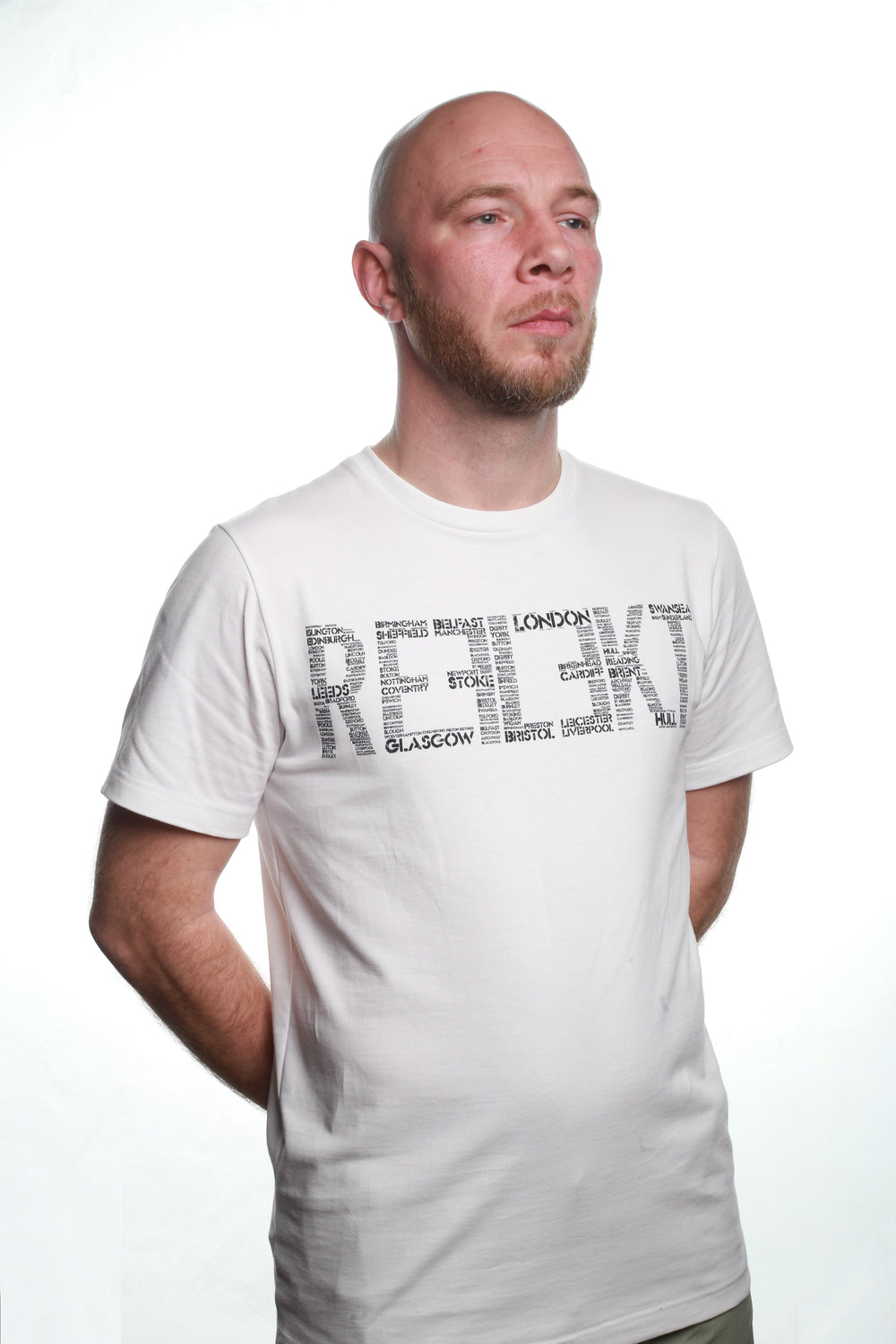 Side view of White REFLEKT Cities T‑shirt with city‑name graphic forming the front wordmark.