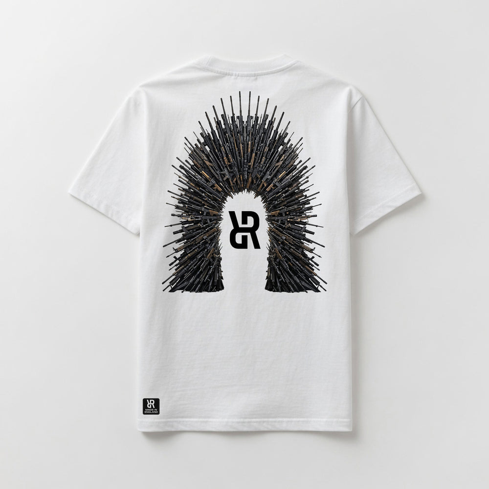 A white short-sleeve t-shirt shown flat against a light gray background, featuring a large graphic on the back with a central stylized 'R' logo surrounded by a crown-like spire of rifles. A small black 'R' logo patch is also visible near the bottom left hem.