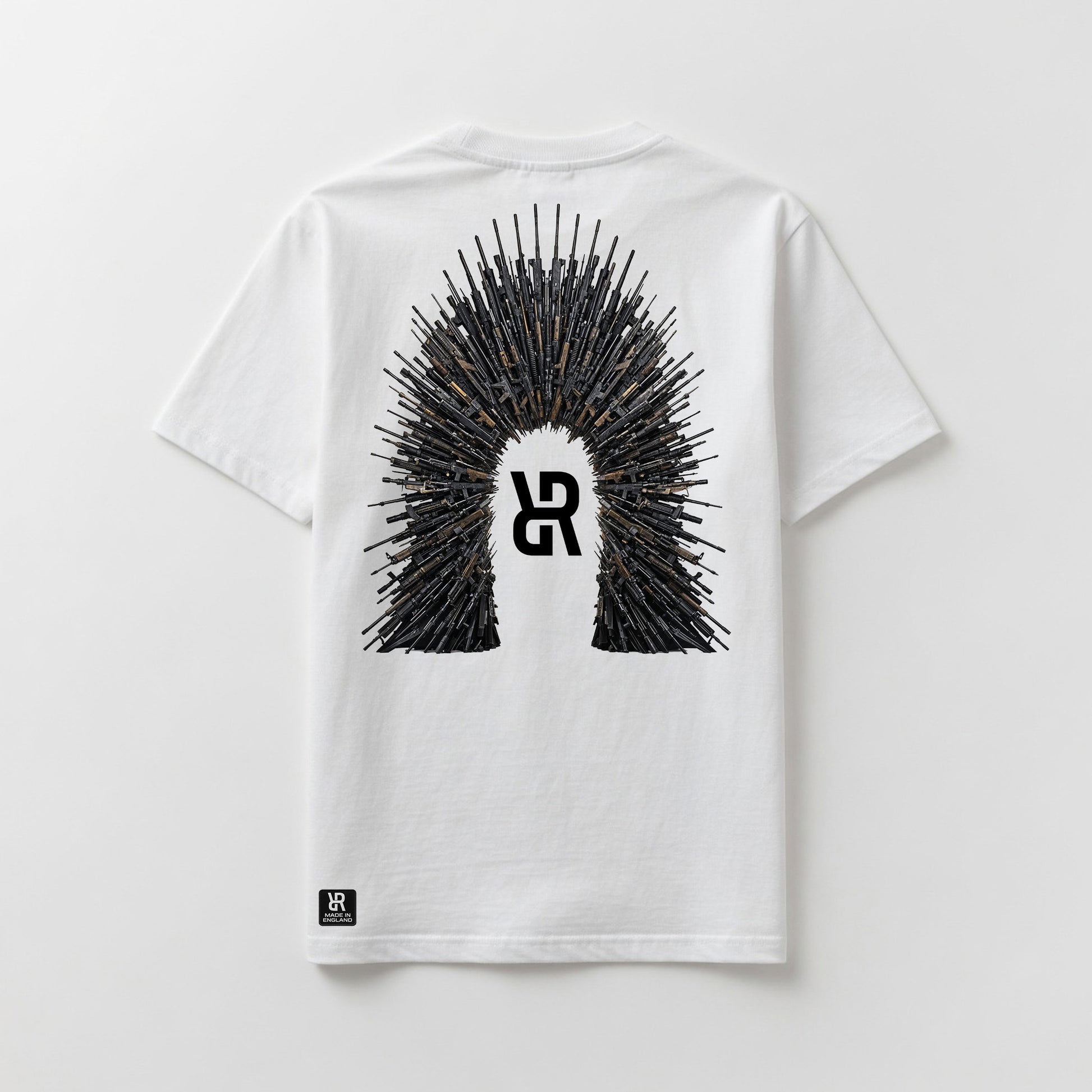 A white short-sleeve t-shirt shown flat against a light gray background, featuring a large graphic on the back with a central stylized 'R' logo surrounded by a crown-like spire of rifles. A small black 'R' logo patch is also visible near the bottom left hem.