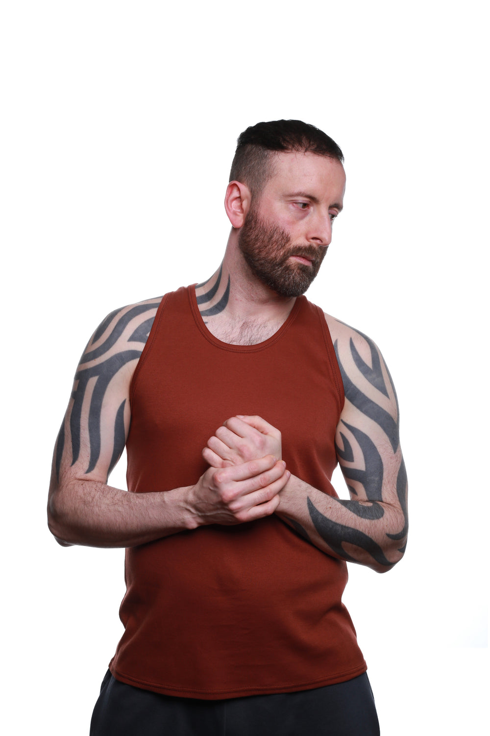 Front view of Rust‑coloured REFLEKT blank vest with racerback design.