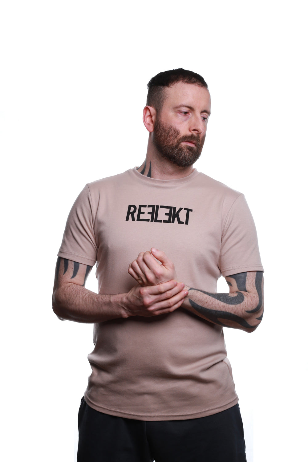 Front view of Stone‑coloured REFLEKT Heritage T‑shirt with bold black front branding and classic crew neckline.