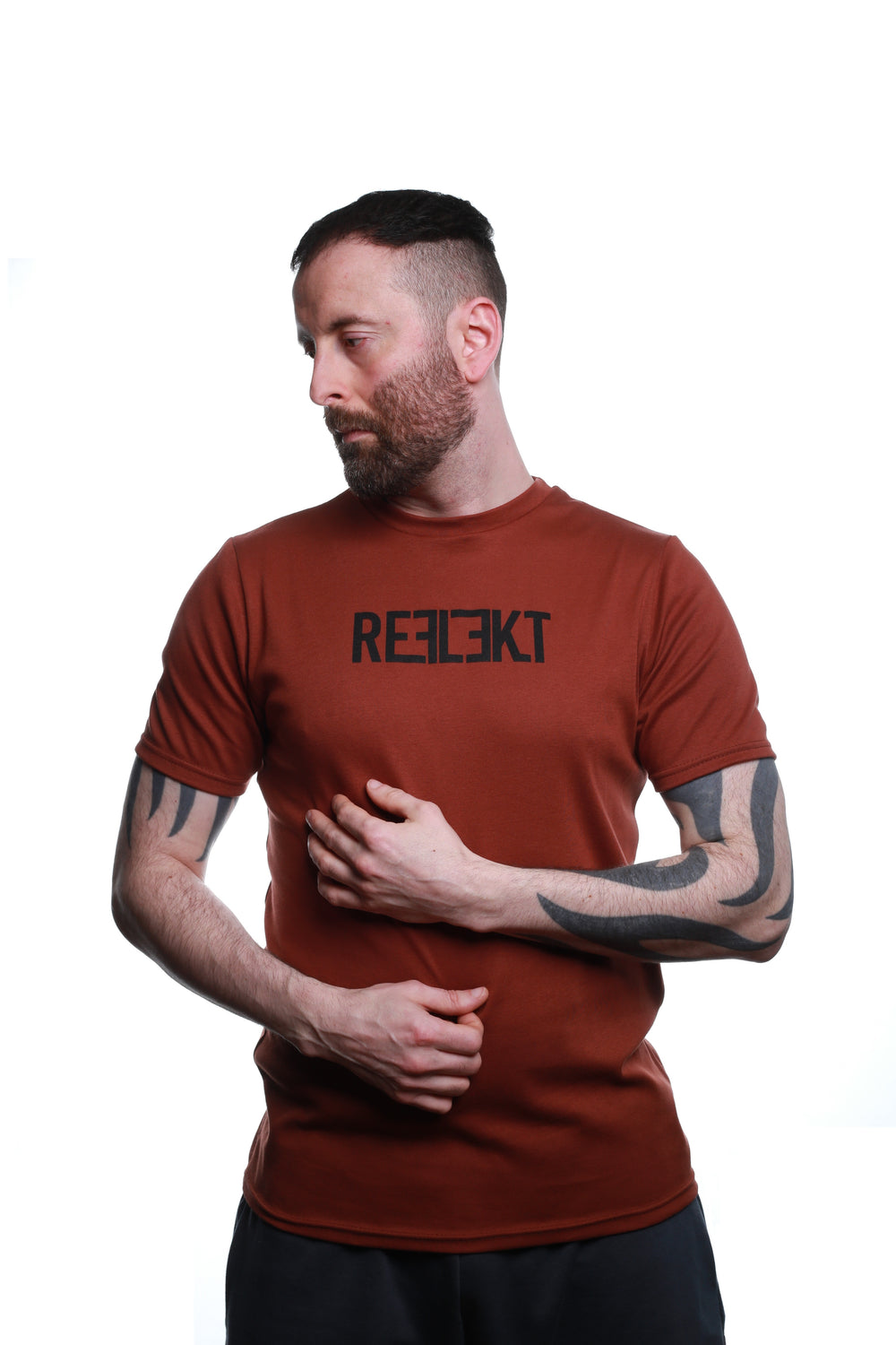 Front view of Rust‑coloured REFLEKT Heritage T‑shirt with bold black front branding and classic crew neckline.