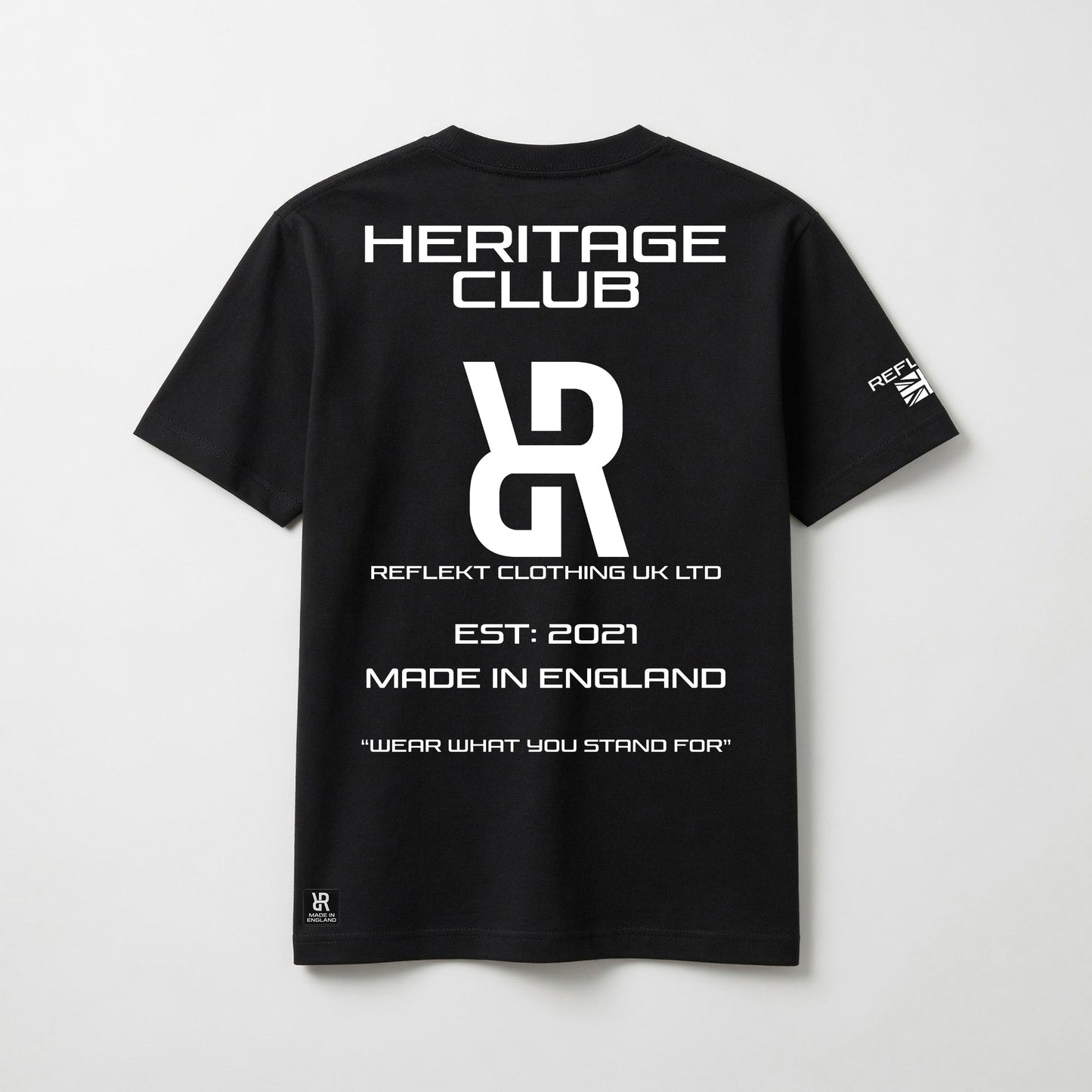 Black t-shirt with white REFLEKT Heritage text and branding on a light gray background