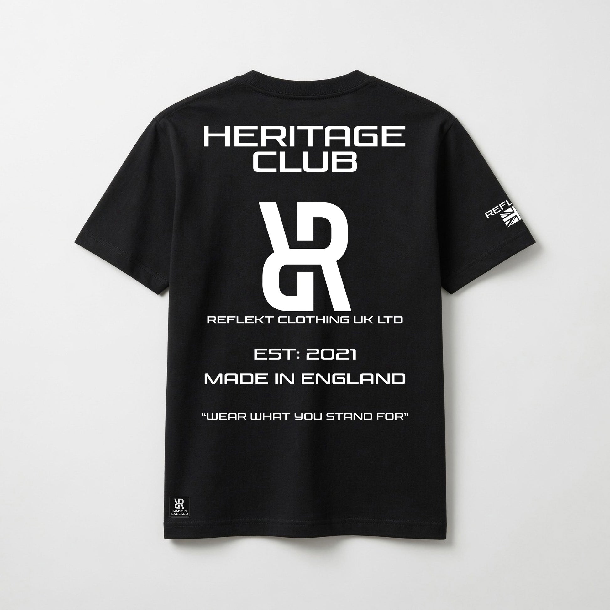 Black t-shirt with white REFLEKT Heritage text and branding on a light gray background