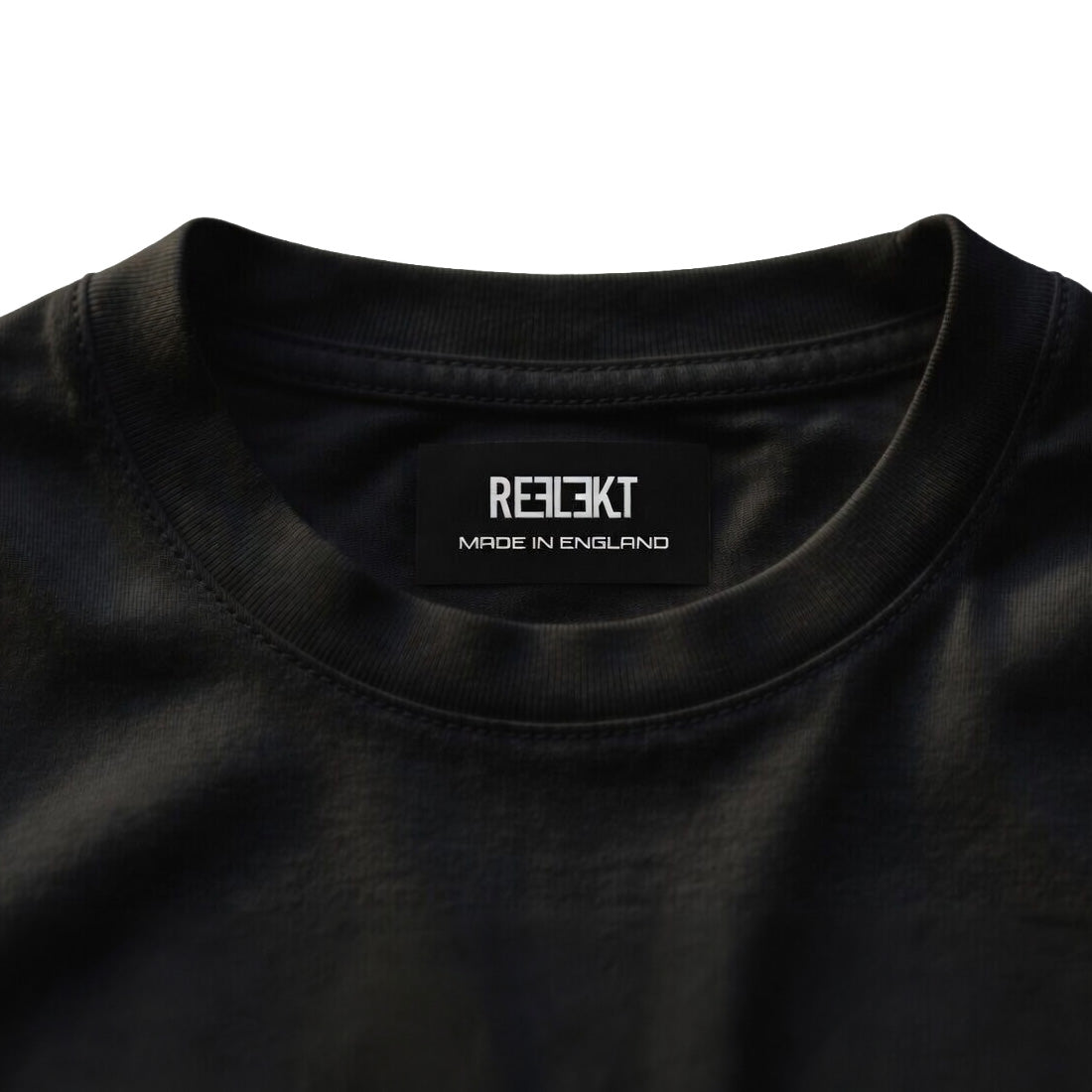 Black shirt with 'REFLEKT' brand label on a white background