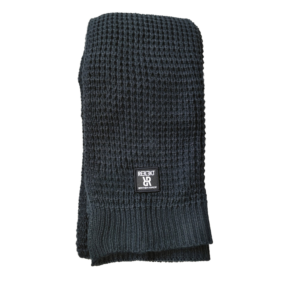Front view of Black REFLEKT waffle‑knit scarf with front woven British‑made label.
