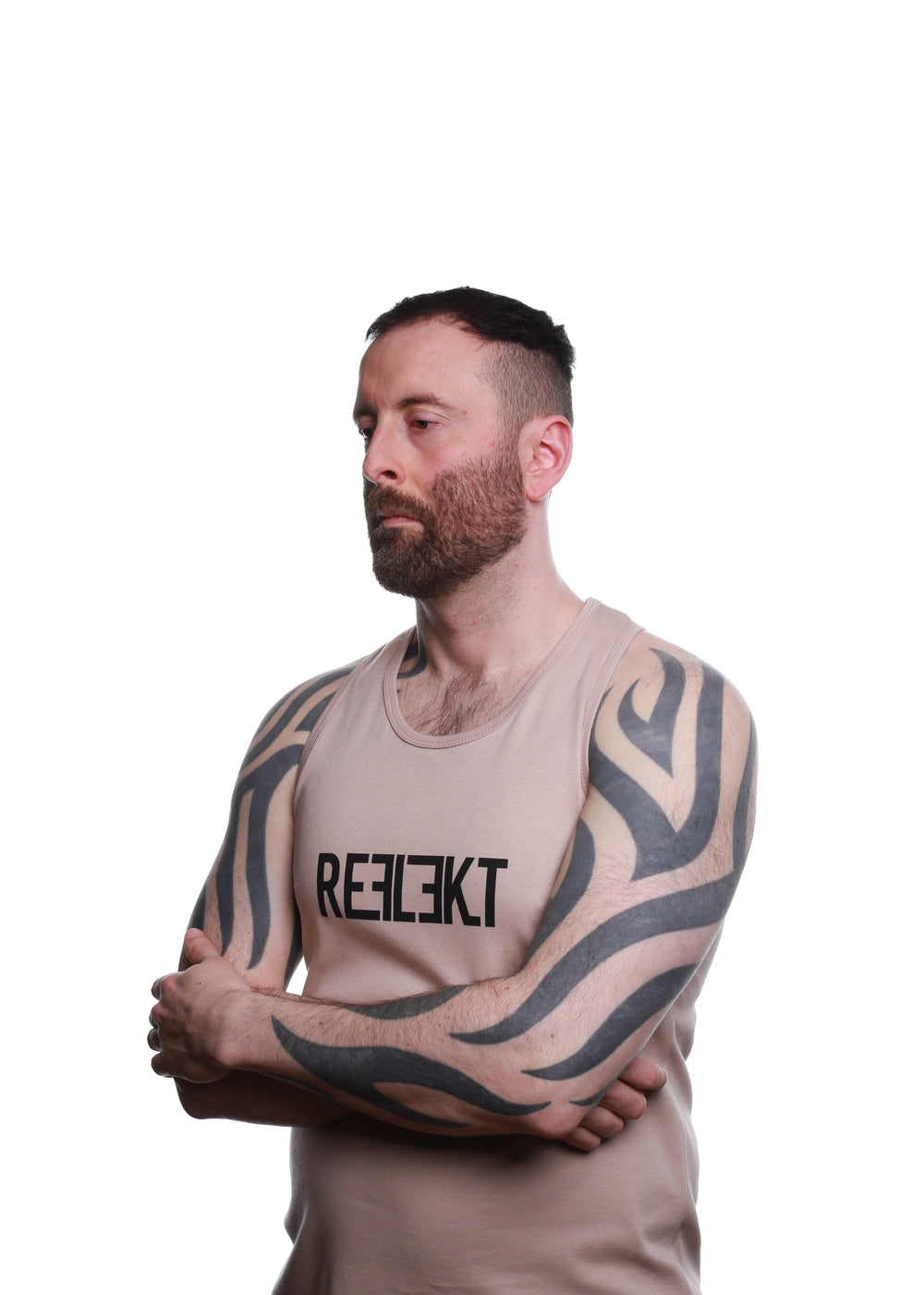 Side view of Stone‑coloured REFLEKT Heritage vest with bold black front branding and racerback design.