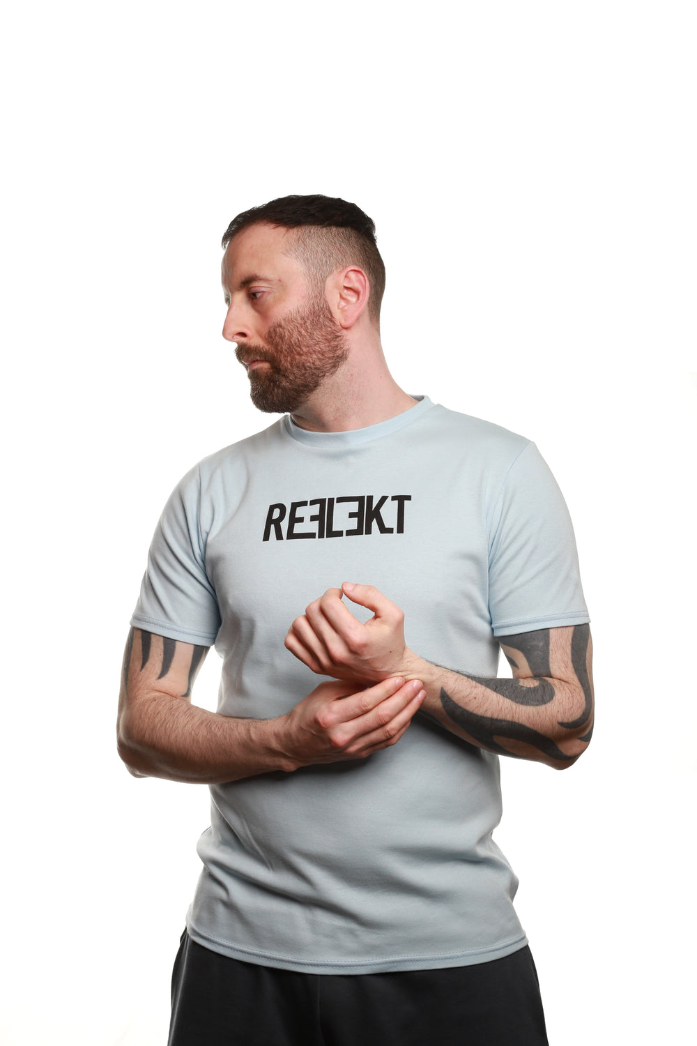 Front view of Sky‑coloured REFLEKT Heritage T‑shirt with bold black front branding and classic crew neckline.