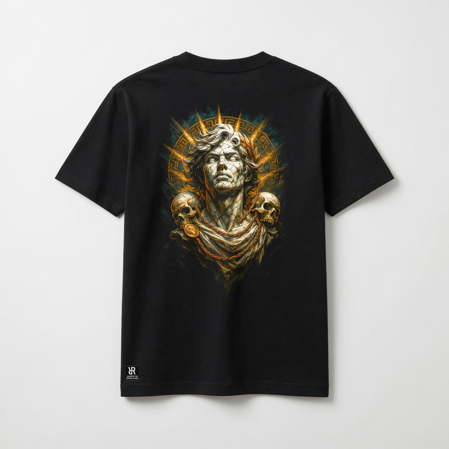 A black short-sleeve t-shirt with a large graphic print on the back featuring a classical bust, skulls, and a golden sunburst, displayed against a light gray background.