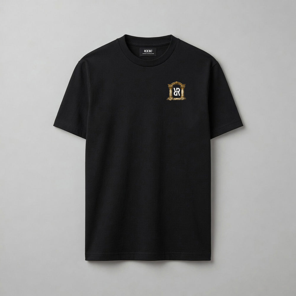 A black short-sleeve crewneck t-shirt with a small gold and white crest logo on the left chest, displayed flat against a neutral gray background.