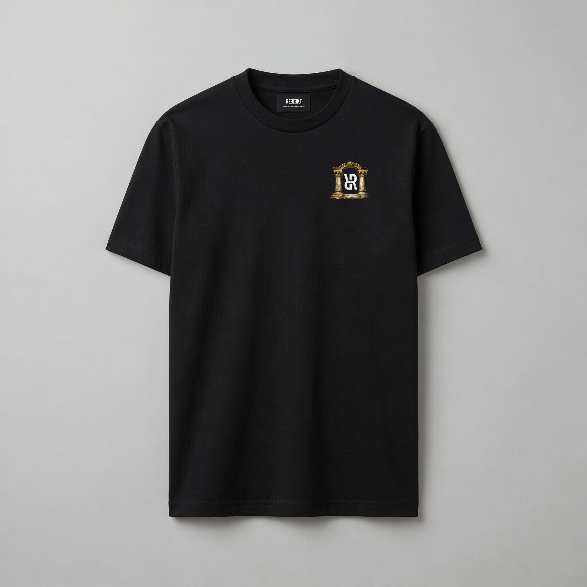 A black short-sleeve crewneck t-shirt with a small gold and white crest logo on the left chest, displayed flat against a neutral gray background.