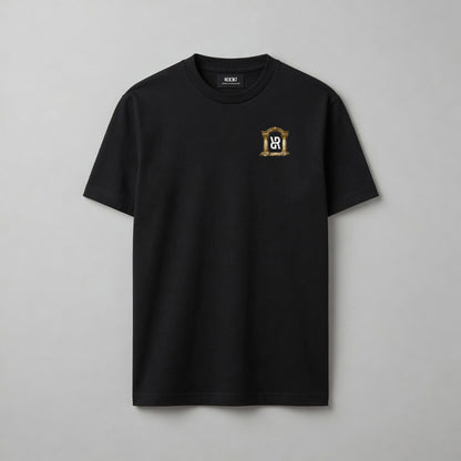 A black short-sleeve crewneck t-shirt with a small gold and white crest logo on the left chest, displayed flat against a neutral gray background.